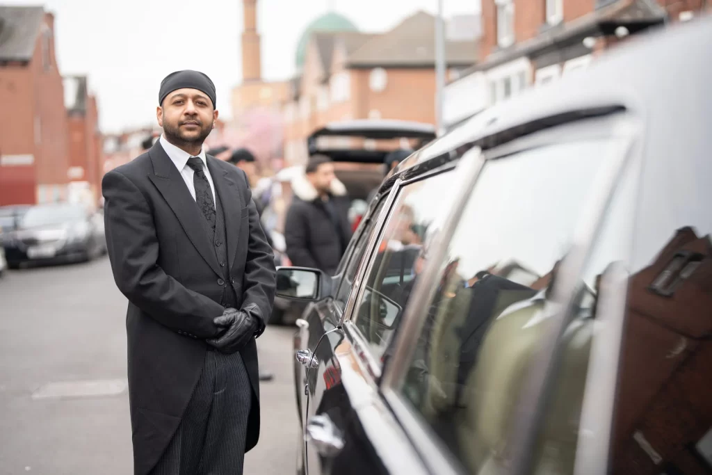 The funeral director of Asian Funeral Homes, Anand, at a funeral in Leeds